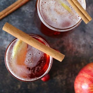 This apple cinnamon cranberry mimosa is the perfect easy holiday drink. It's main ingredient is sparkling apple cider so it can also be made into a fauxmosa! | honeyandbirch.com