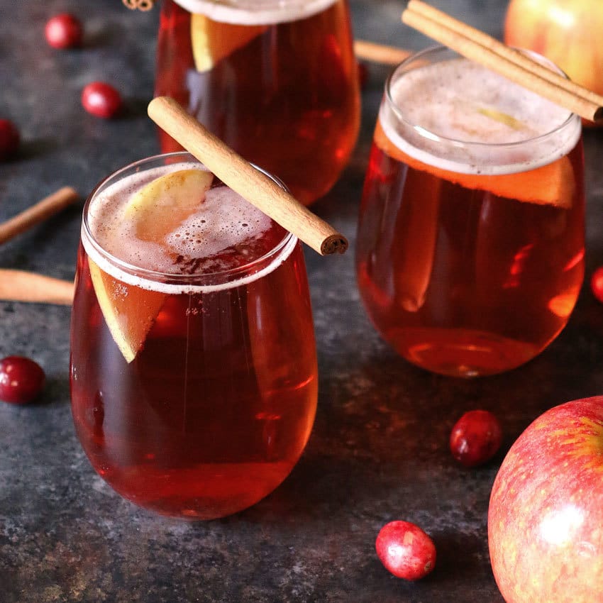 This apple cinnamon cranberry mimosa is the perfect easy holiday drink. It's main ingredient is sparkling apple cider so it can also be made into a fauxmosa! | honeyandbirch.com