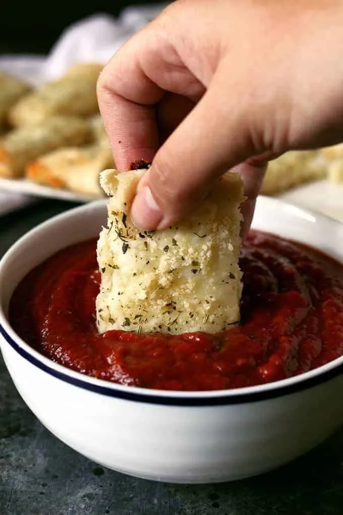 Chicago-Style deep dish breadsticks dipped into pizza sauce