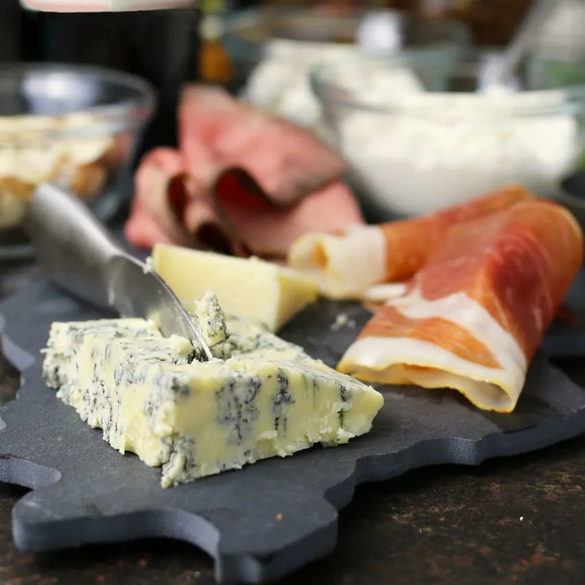 blue cheese and prosciutto on slate cutting board