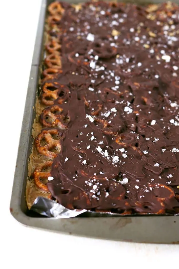 Salted caramel chocolate pretzel bark on a sheet pan