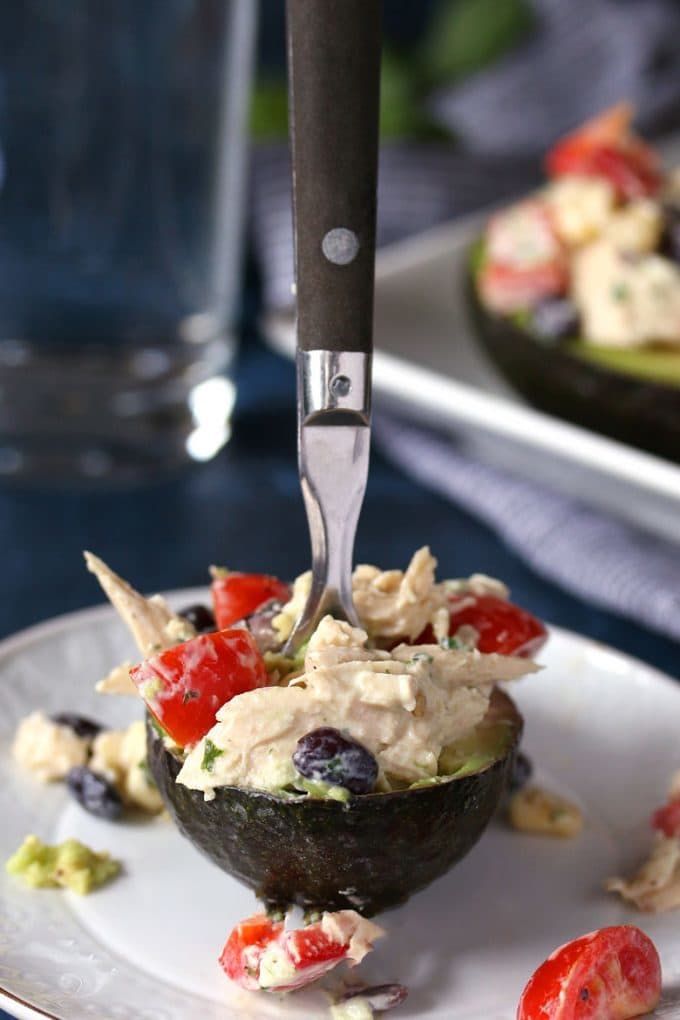 southwest chicken salad stuffed avocado recipe and a fork