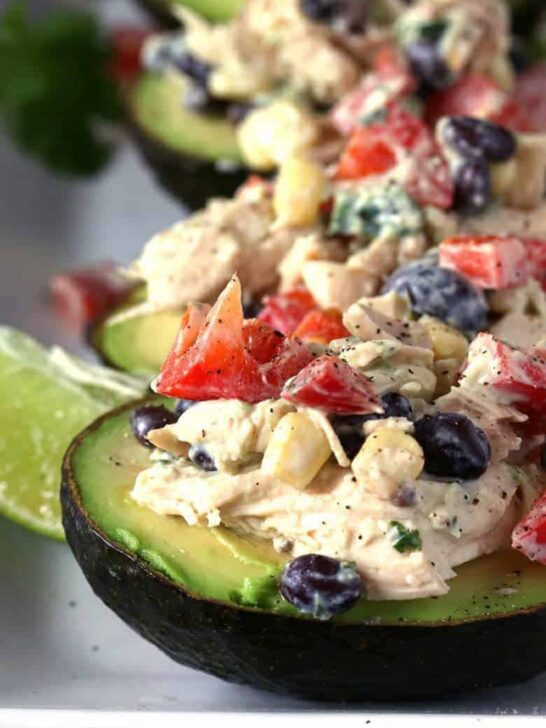 This southwest chicken salad stuffed avocado recipe is perfect for dinners or lunches! Use rotisserie chicken to whip up this healthy meal quickly. | honeyandbirch.com