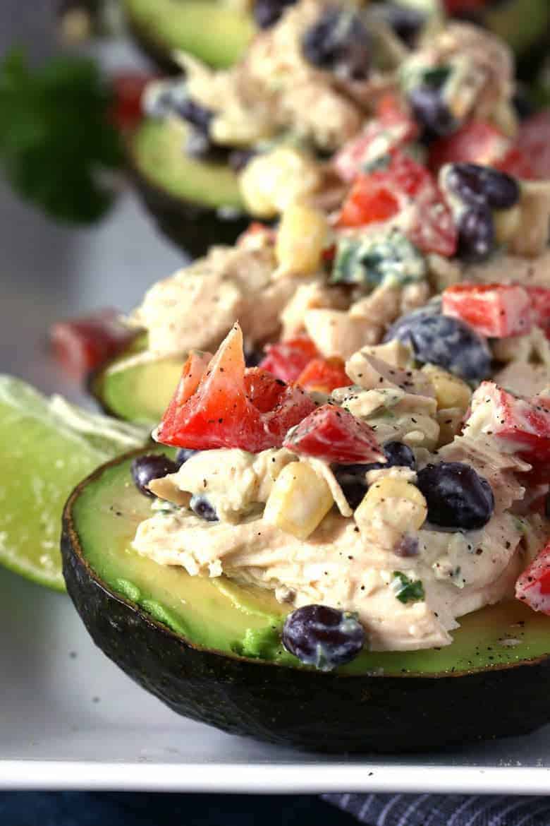 This southwest chicken salad stuffed avocado recipe is perfect for dinners or lunches! Use rotisserie chicken to whip up this healthy meal quickly. | honeyandbirch.com
