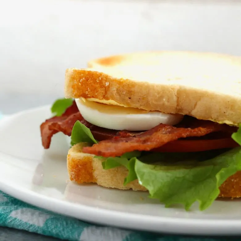 This deviled egg BLT sandwich is the perfect lunch. Make small-batch deviled eggs on demand with this recipe and enjoy your favorite sandwich at the same time! | honeyandbirch.com