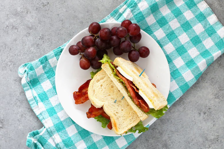 This deviled egg BLT sandwich is the perfect lunch. Make small-batch deviled eggs on demand with this recipe and enjoy your favorite sandwich at the same time! | honeyandbirch.com