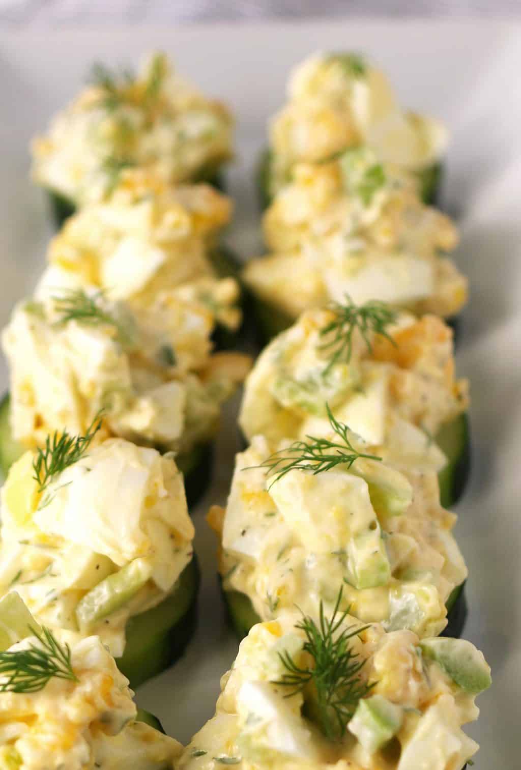 plate full of egg salad cucumber canapés