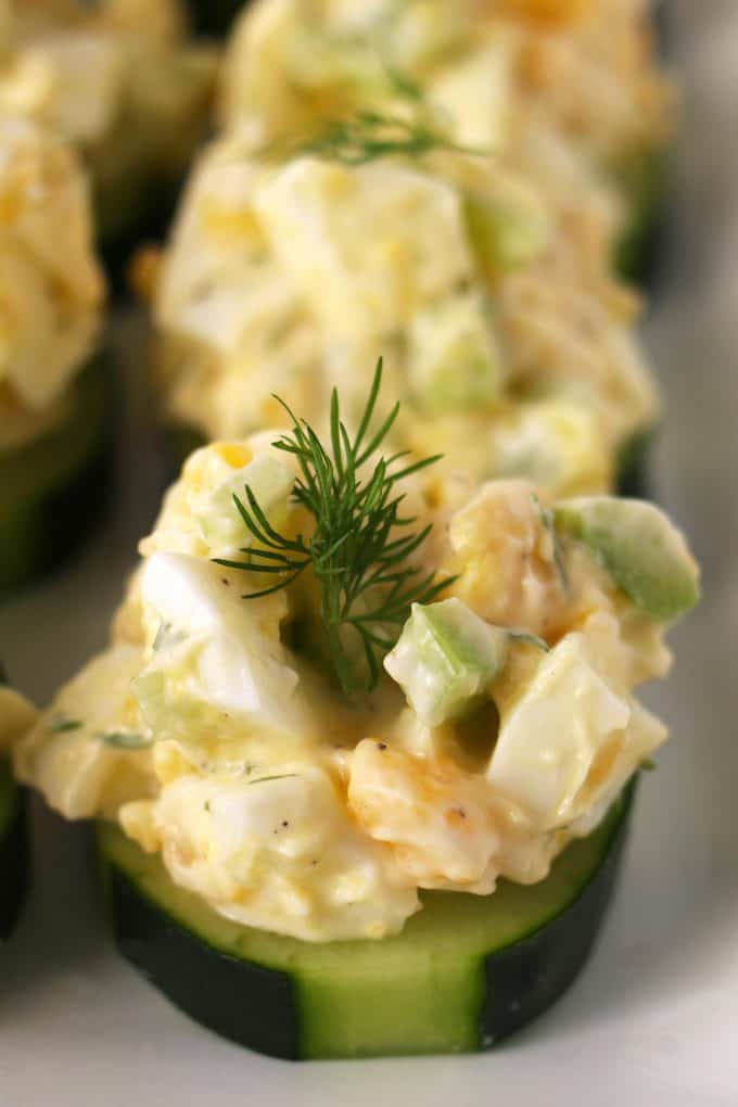 egg salad cucumber canapé on a white plate