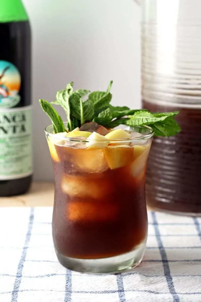bottle of branca menta, one apple iced tea mint cocktail and pitcher of iced tea