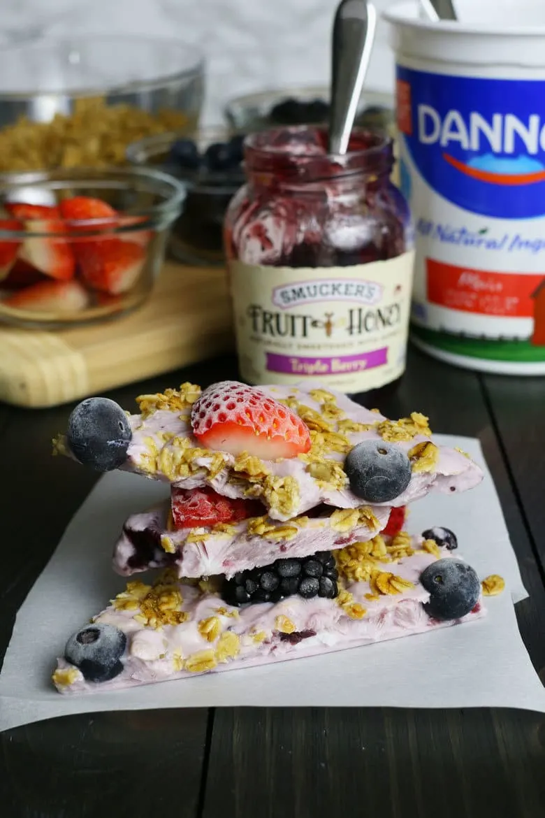 This triple berry granola frozen yogurt breakfast bark is perfect for busy mornings. It's like eating a make-ahead breakfast parfait popsicle and is great for feeding a crowd! Stack of granola