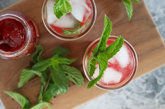 overhead photo of 2 mint strawberry jam cocktails