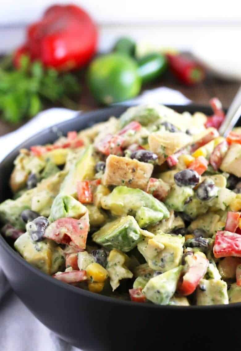 grilled chicken avocado salad in a black bowl