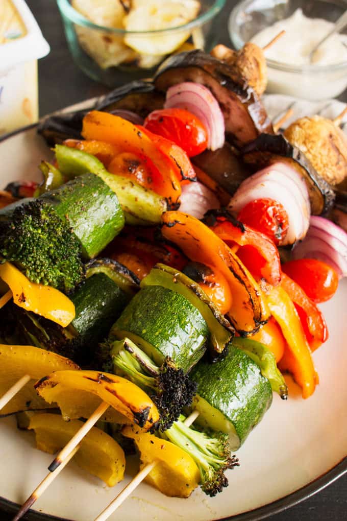 These rainbow veggie kabobs are the perfect summer side dish! Serve them with my delicious and easy to make grilled lemon garlic sauce.