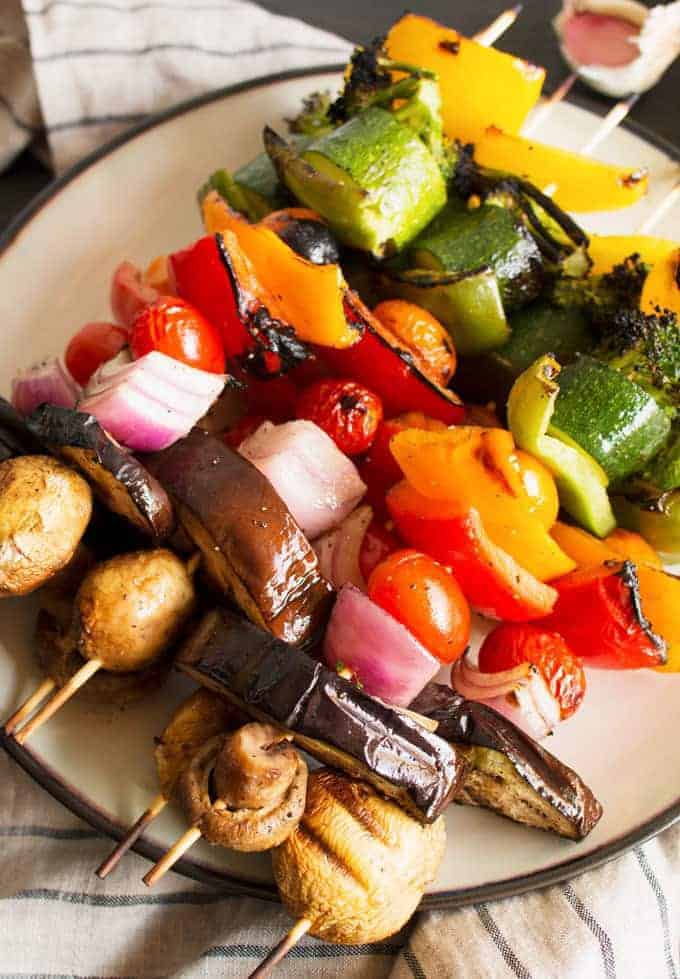 These rainbow veggie kabobs are the perfect summer side dish! Serve them with my delicious and easy to make grilled lemon garlic sauce.