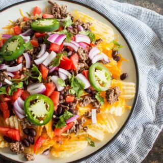 Last-minute tailgating party? Make these easy potato chip nachos with all of your favorite toppings! This is going to become your favorite game day food.