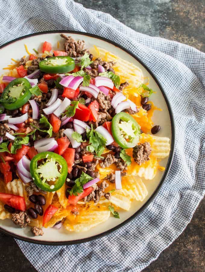Last-minute tailgating party? Make these easy potato chip nachos with all of your favorite toppings! This is going to become your favorite game day food.