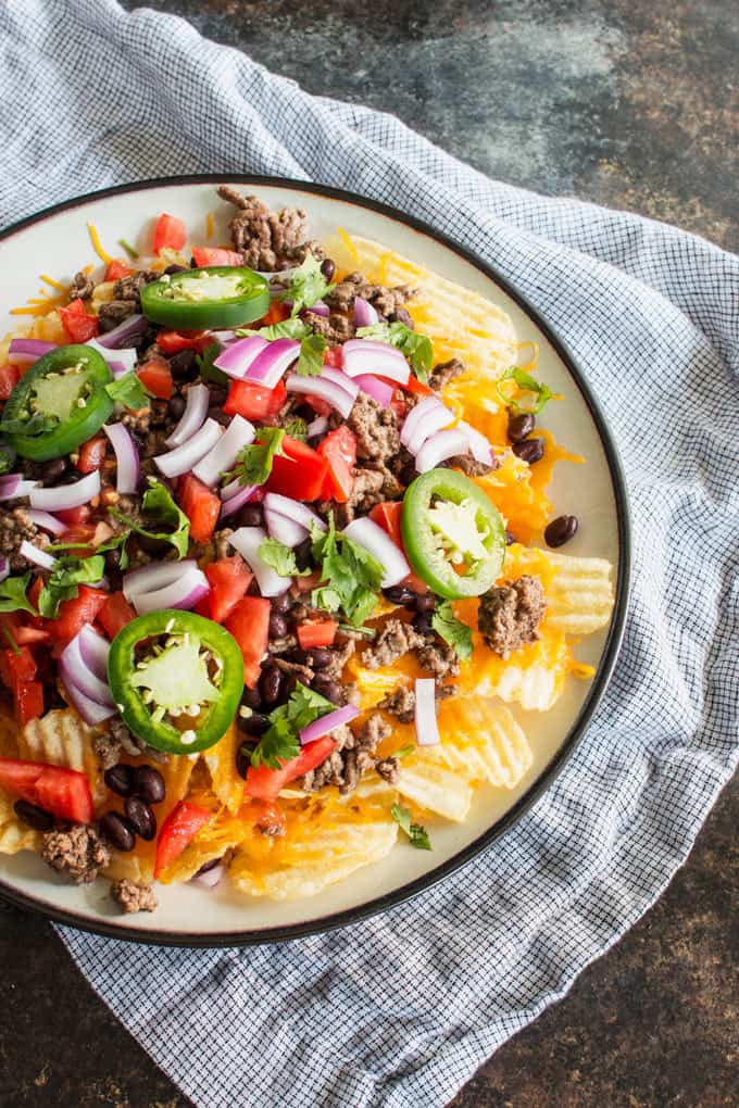 Last-minute tailgating party? Make these easy potato chip nachos with all of your favorite toppings! This is going to become your favorite game day food.