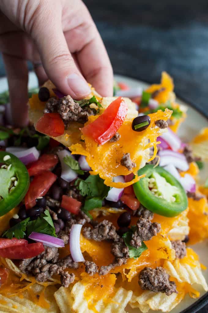 Last-minute tailgating party? Make these easy potato chip nachos with all of your favorite toppings! This is going to become your favorite game day food.