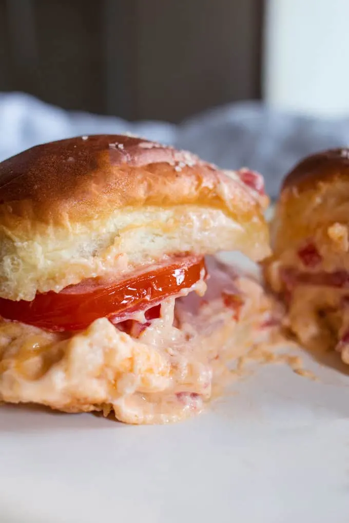 Pimento cheese tomato ham sliders are the perfect party food! Perfect for big crowds, these flavorful sandwiches will be the star of your next event.