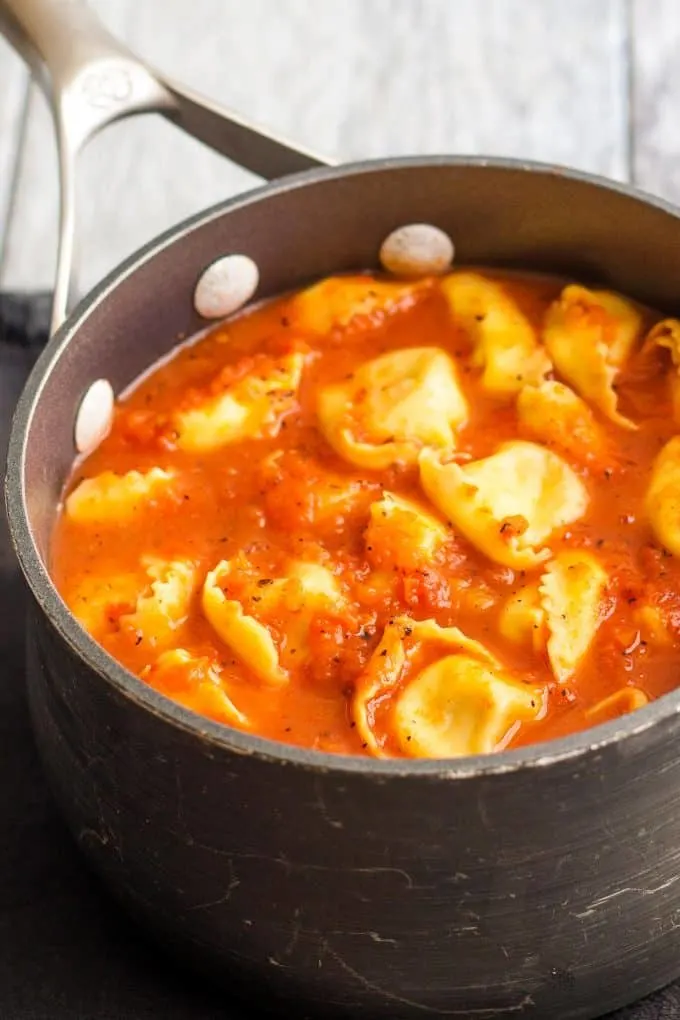 pot full of soup with tortellini