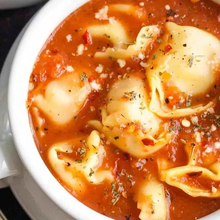 overhead photo of tomato soup with tortellini