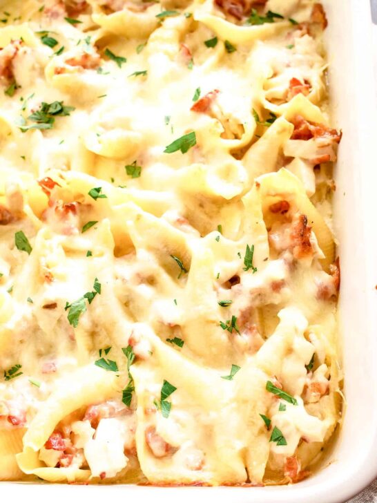 chicken bacon Alfredo stuffed shells in a white casserole dish