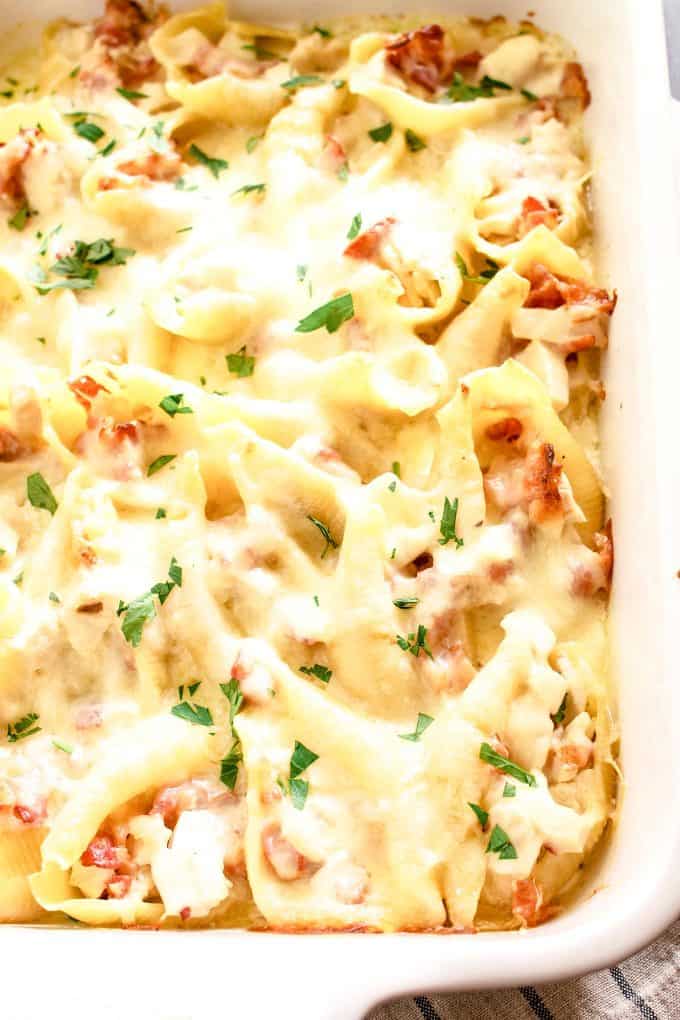 chicken bacon Alfredo stuffed shells in a white casserole dish