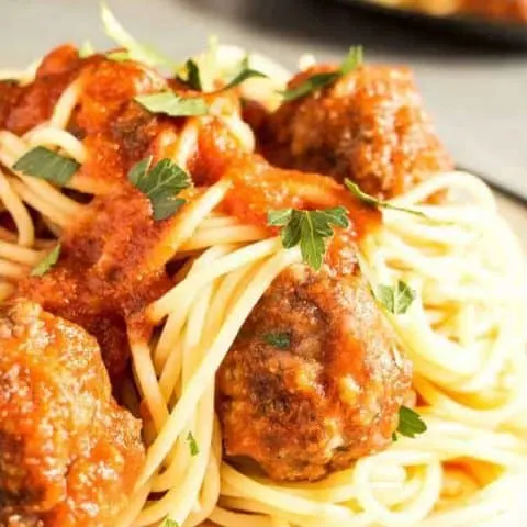 This easy homemade spaghetti and meatballs recipe is perfect for busy weeknights. Prep the meatballs the day before and then pop them in the oven when it's time for dinner!