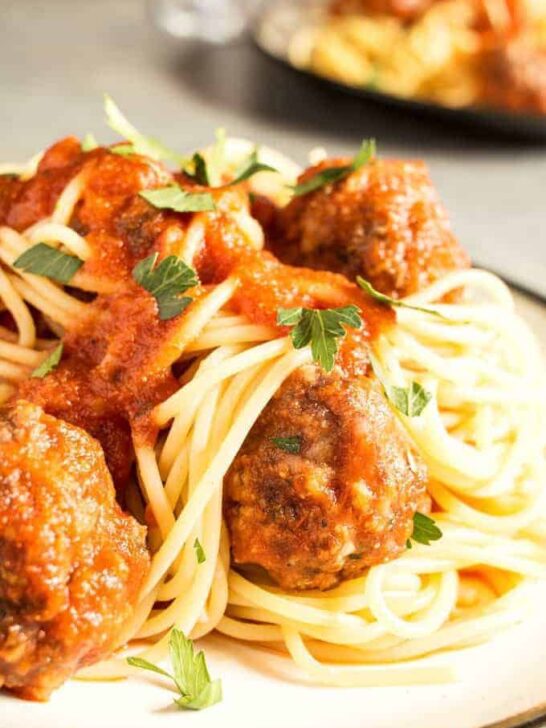 This easy homemade spaghetti and meatballs recipe is perfect for busy weeknights. Prep the meatballs the day before and then pop them in the oven when it's time for dinner!