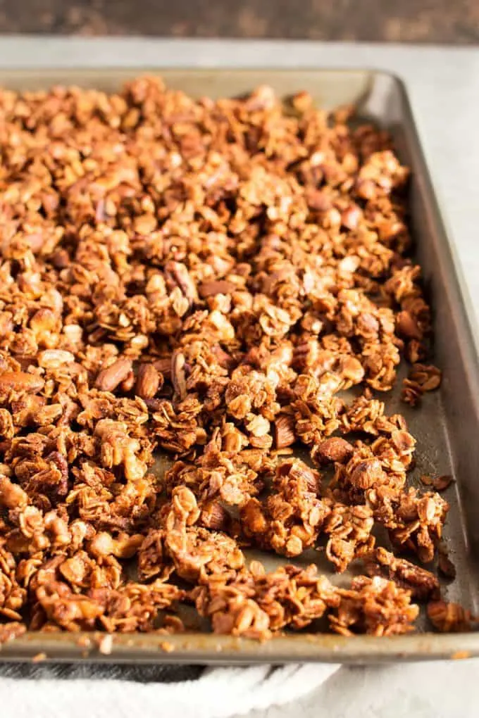 homemade granola recipe on a baking sheet after it has been cooked in the oven