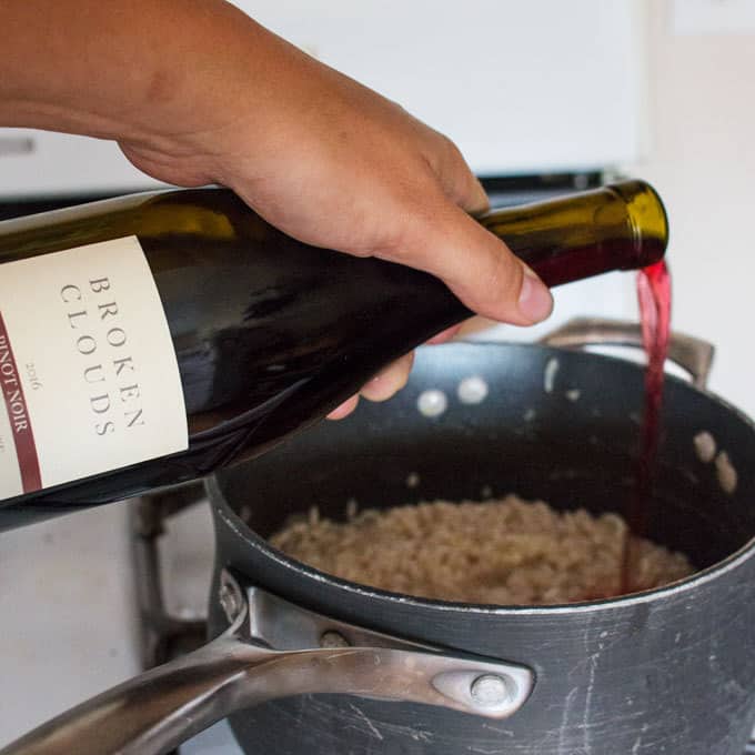 red wine being poured into pot