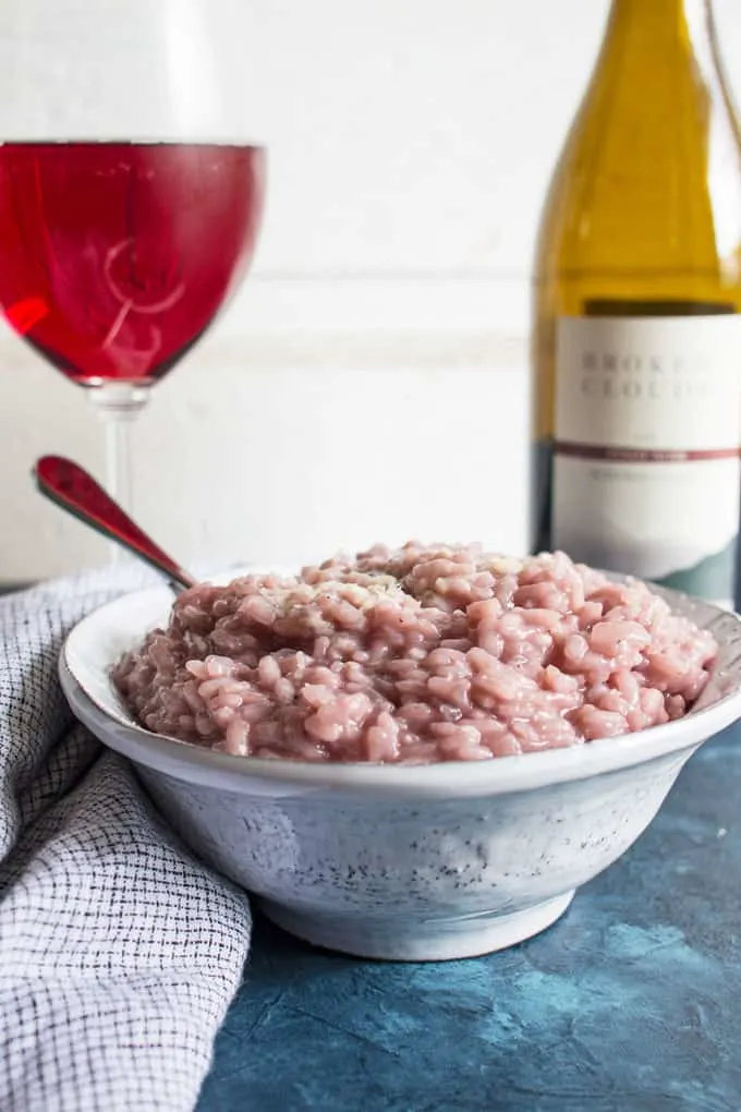 red wine risotto in a pottery bowl