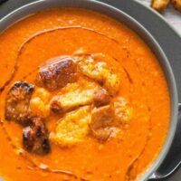 bowl of brie and roasted red pepper soup with brioche croutons