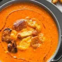 bowl of brie and roasted red pepper soup with brioche croutons