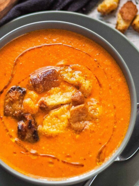 bowl of brie and roasted red pepper soup with brioche croutons