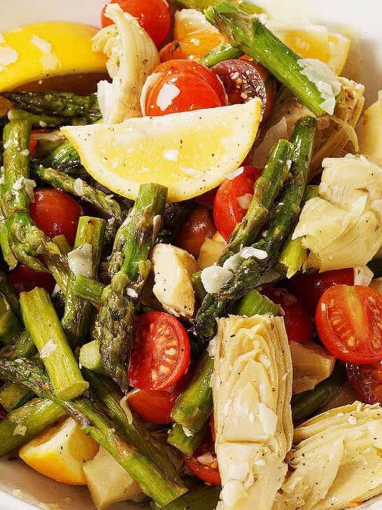 close up photo of asparagus and cherry tomato salad