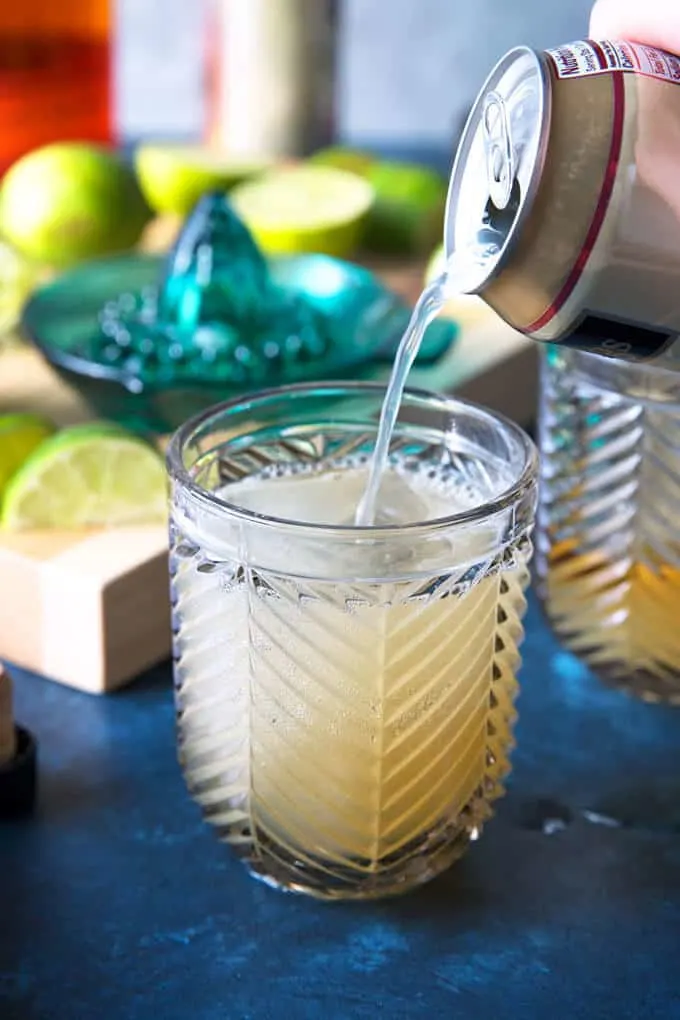 ginger beer being poured into a Kentucky Mule