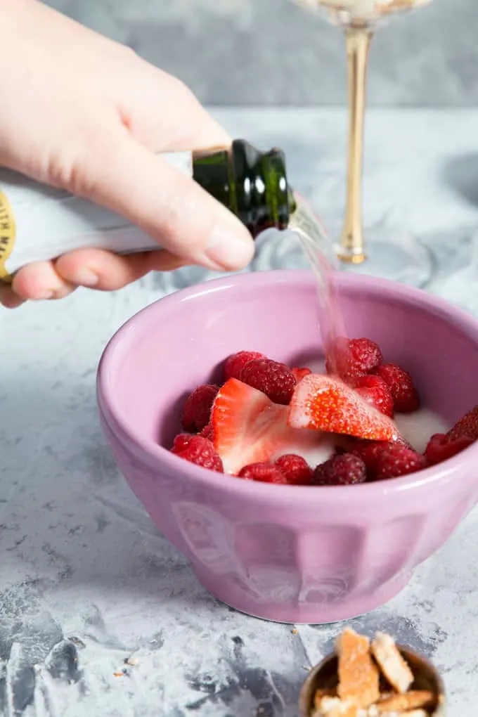 sparkling cider poured over strawberries and raspberries