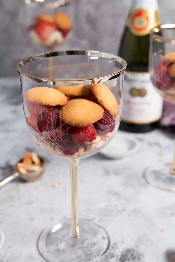 vanilla wafer cookies and berries in a wine glass