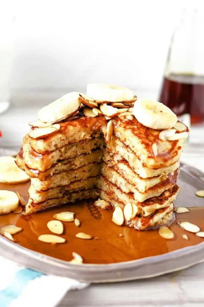 stack of almond banana pancakes with a section cut out