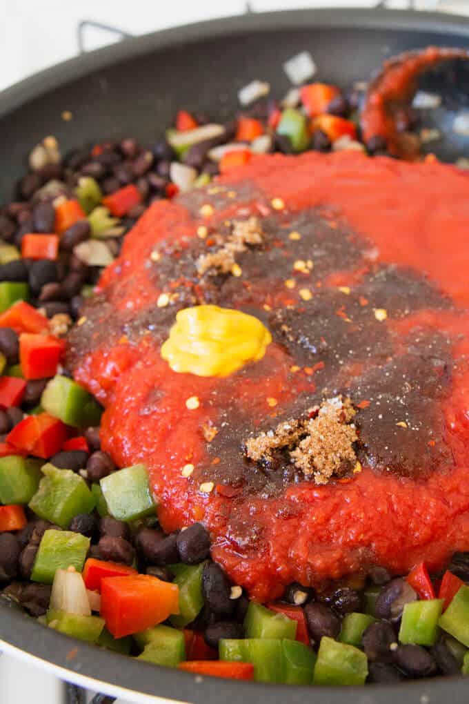 all of the ingredients for black bean sloppy joes in a pan