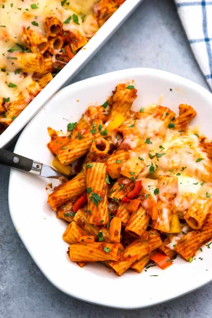 bowl of chorizo rigatoni casserole with casserole dish in the background