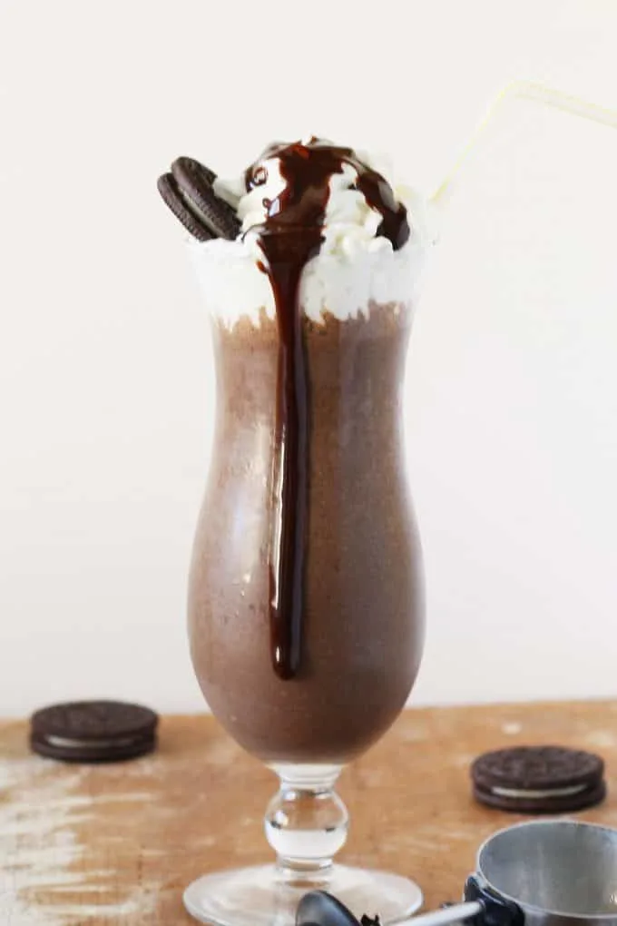 coffee cookies and cream cookie milkshake in a tall glass