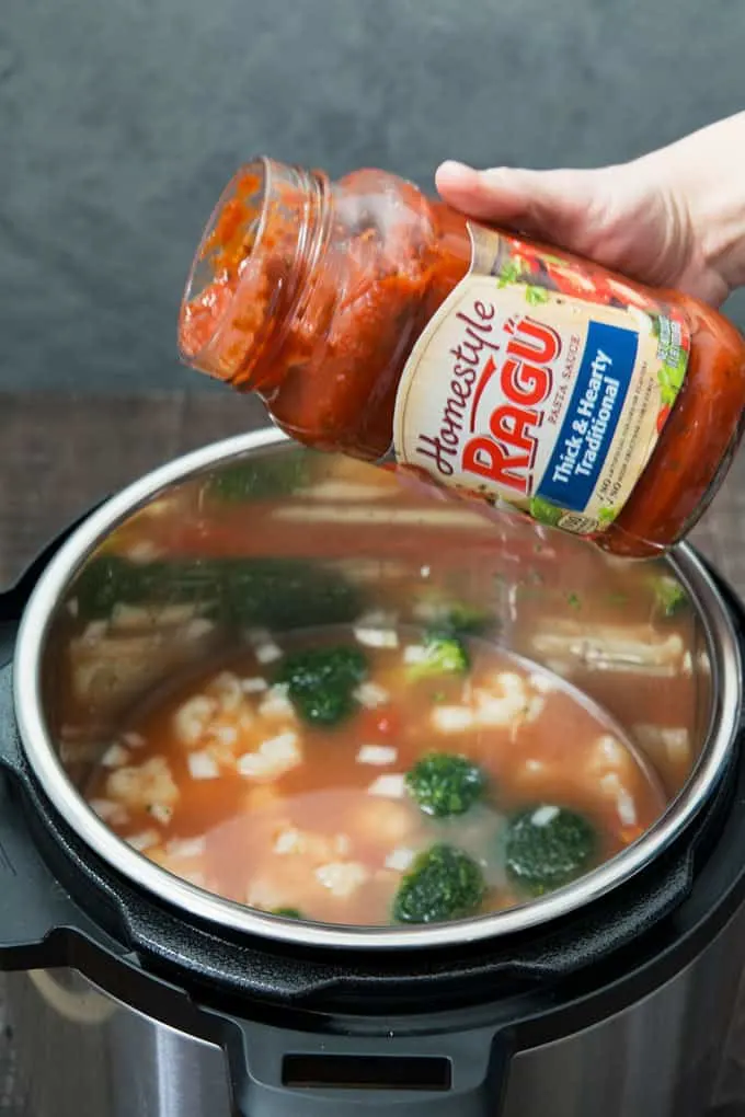 ragu sauce being poured into instant pot