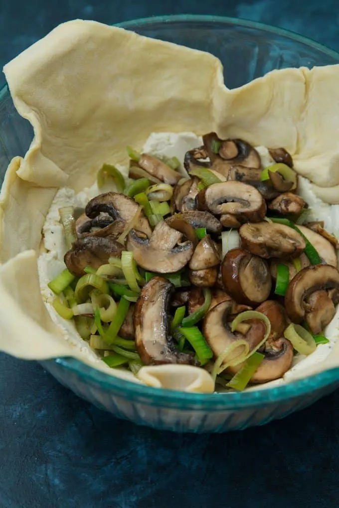 leek mushroom cheese stuffed puff pastry being prepared in a bowl