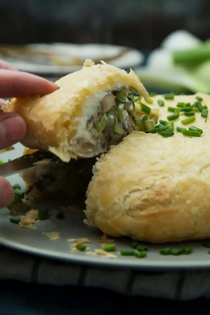 picture of leek mushroom cheese stuffed puff pastry piece being removed