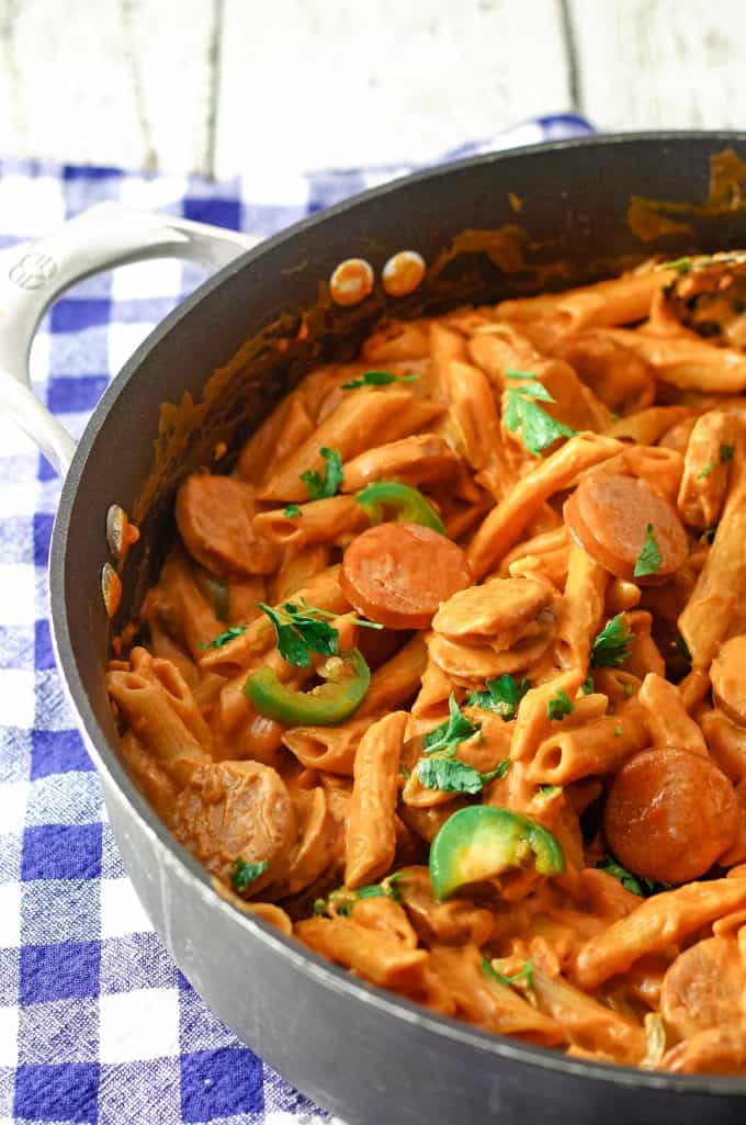 one pot spicy sausage pasta skillet in a black skillet