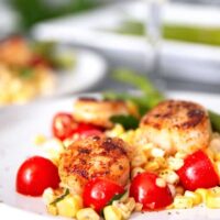 seared garlic scallops and a glass of white wine