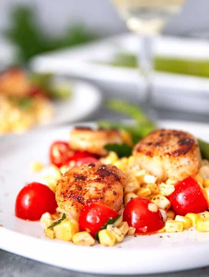 seared garlic scallops and a glass of white wine