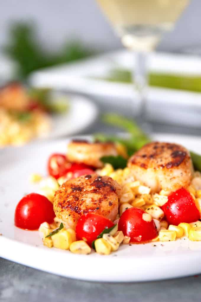 seared garlic scallops and a glass of white wine